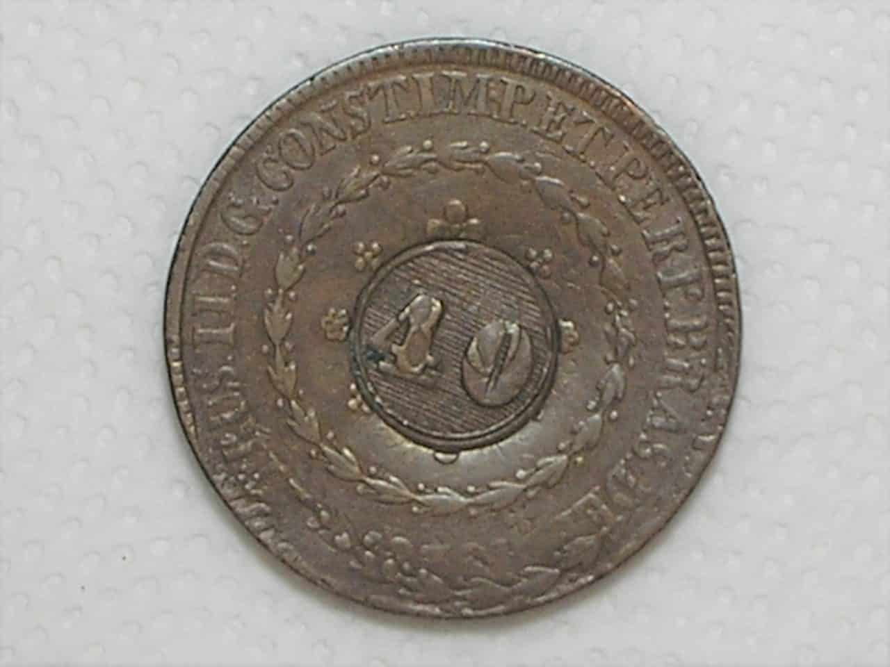 | Casa do Colecionador 80 Réis – 1832 - Rio / Recunhada sobre outro 80 Réis do Império / 20 tulipas / Carimbo 40/ Raro / Império D. Pedro I / Cobre / Mbc / box21