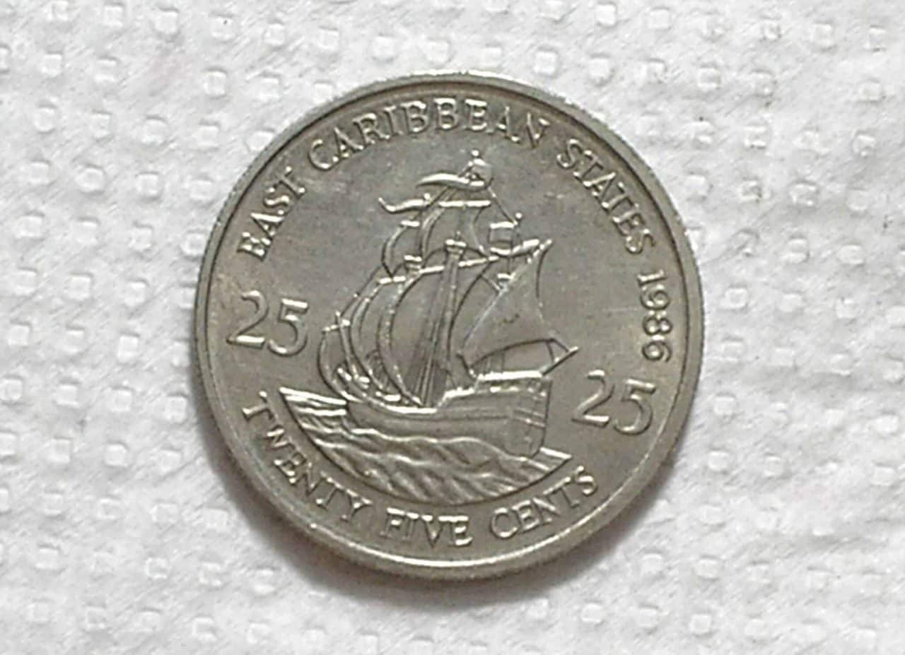 | Casa do Colecionador East Caribbean State) 25 Cents - 1986 / 24mm / Co/Ni / Flor de Cunho / box53