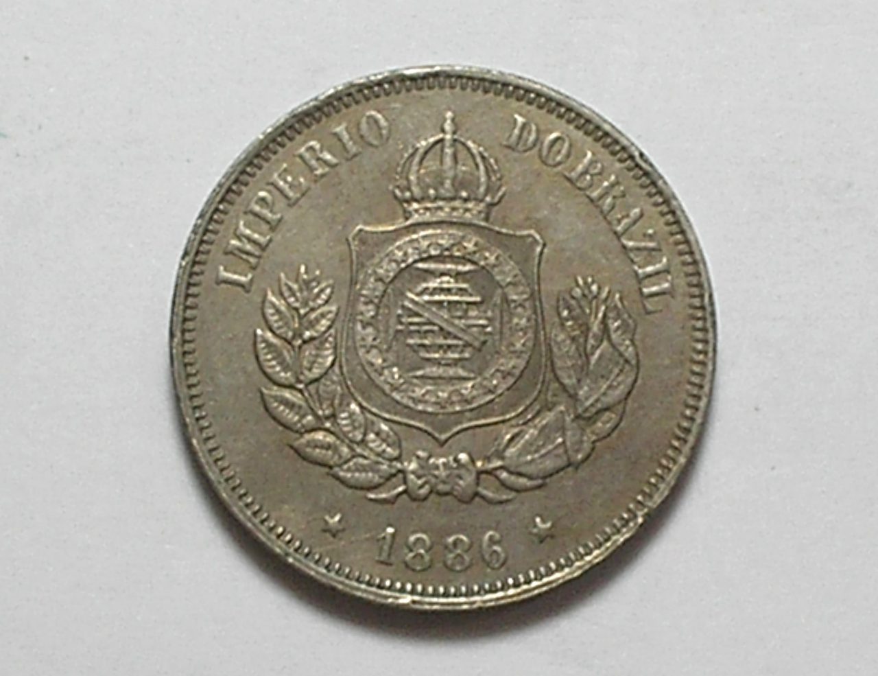 | Casa do Colecionador 50 Réis - 1886 / Fundo Linhado / Flor de cunho - raro no estado / Níquel