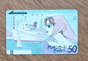I26. Cartão telefone Japão Ntt 250. Yokohama navio mulher com lenço.